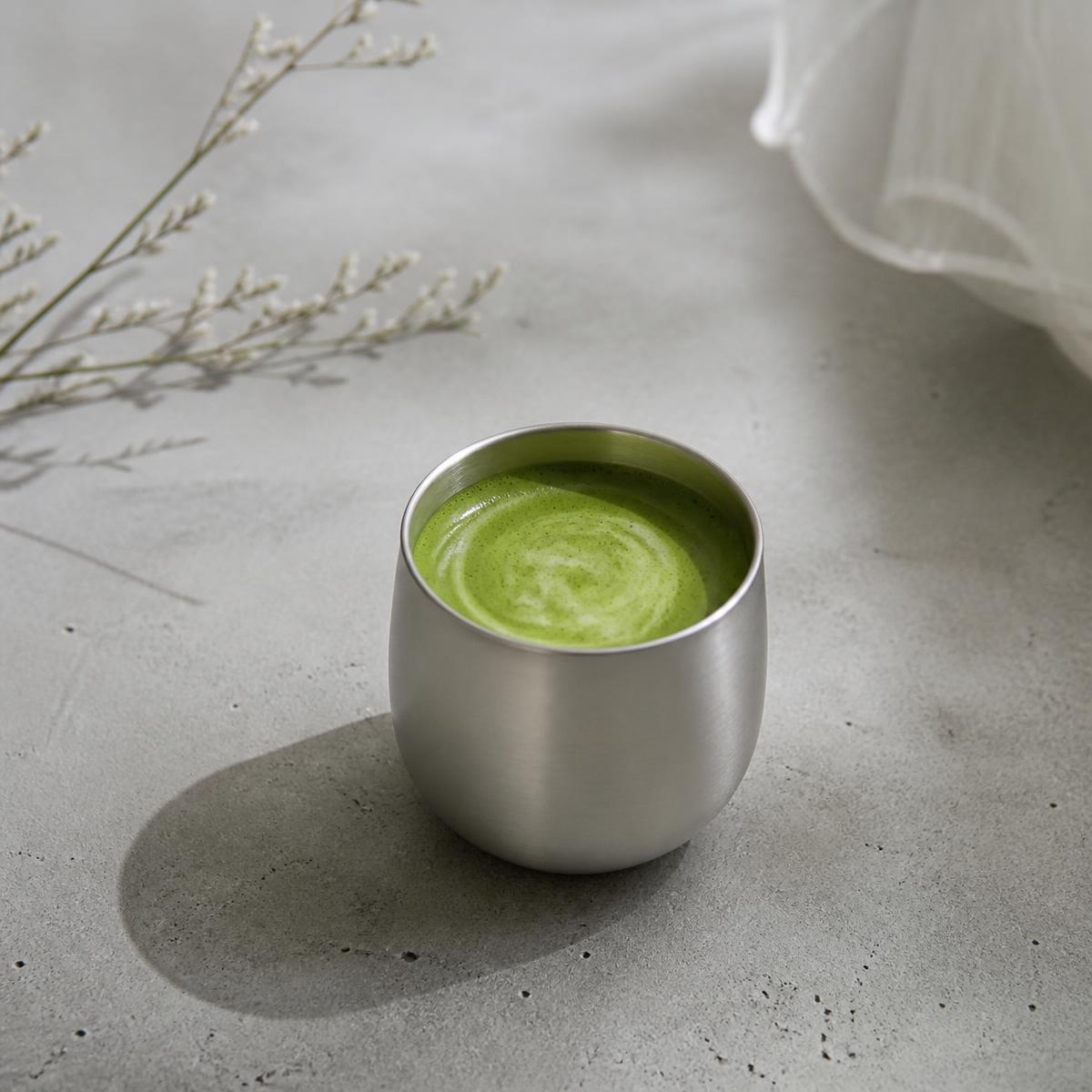 OJI matcha served in a brushed aluminum cup